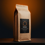  VIGORYS RISE Mushroom Coffee Blend 16oz kraft bag at angle with dramatic orange glow showing side gusset and front label, adaptogenic mushroom coffee - CORE Protocol